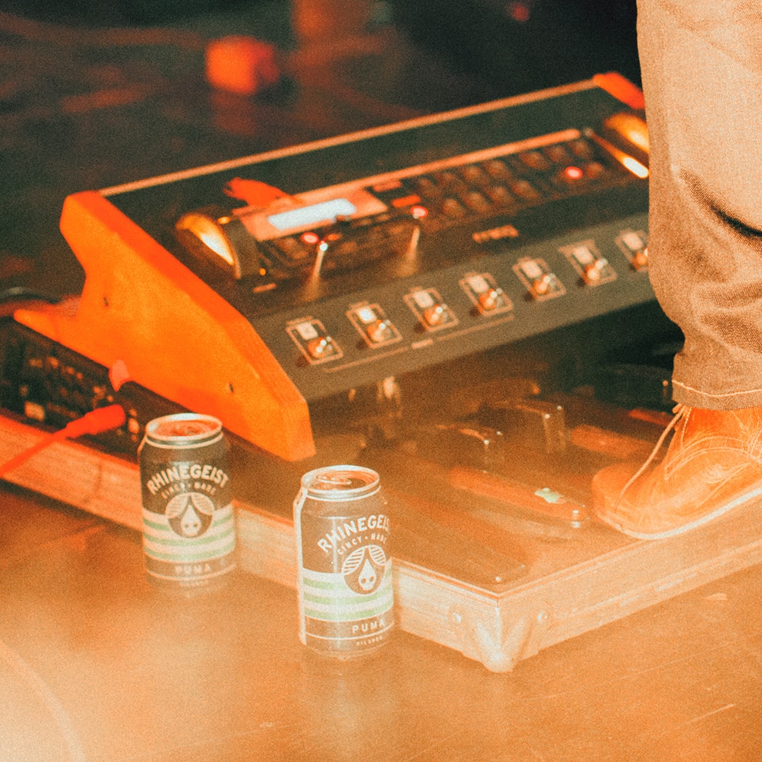 Pedalboards and Rhinegeist beer on a stage in Cincinnati